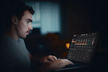 A cheerful woman in traditional clothing using her smartphone during a festive moment, showing how easily the 88FD app fits into everyday life.